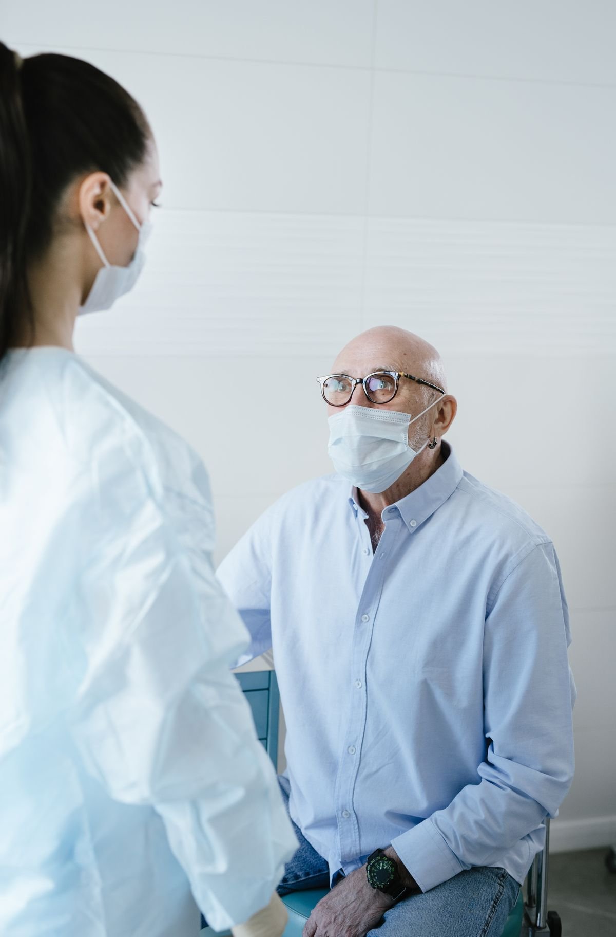 Hombre mayor mirando atentamente a su médico durante examen de salud